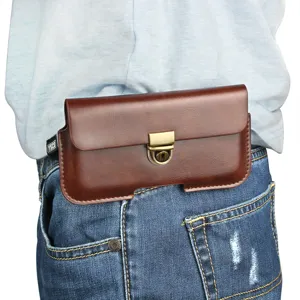 Close-up detail of a brown leather waist phone pouch with metal lock buckle worn on jeans.