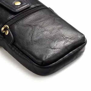 Gros plan sur le sac de taille en cuir noir montrant une texture fine et une fermeture éclair.