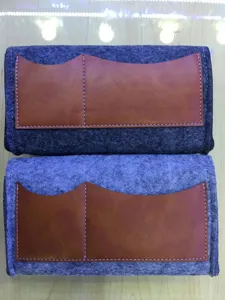 Felt phone storage pouch detail view, brown leather wave pocket design, close-up shot.