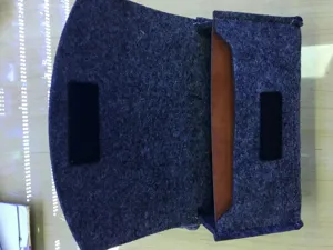 Close-up detail of open grey felt phone pouch with brown inner lining and velcro.