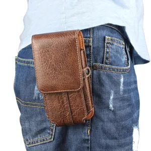 Detailed view of the brown leather texture vertical phone holster worn on belt, durable utility pouch.