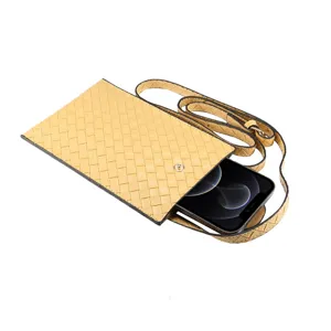 Dettaglio custodia per telefono in pelle intrecciata, tracolla elegante, design a trama raffinata.