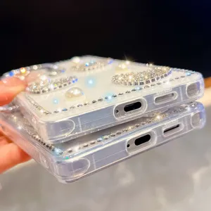 Detailed view of clear sparkling rhinestone and pearl phone case, showing exquisite shining bling design.