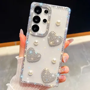 Close-up of clear phone case with sparkling rhinestones, pearls, and heart charms.