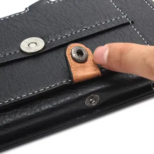 Detailed view of black leather phone pouch metal snap button and magnetic closure.
