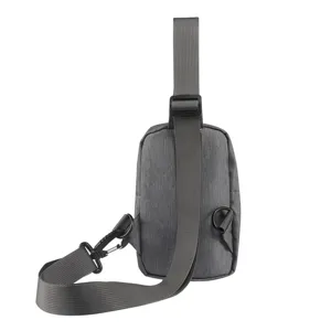 Grey canvas chest bag detail view, showing adjustable strap, D-ring and metal hook hardware.