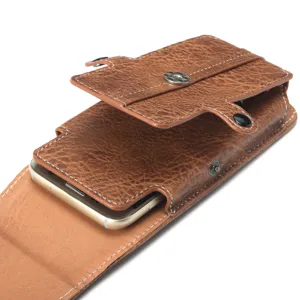 Detailed view of brown leather phone holster, textured waist pouch with magnetic snap closure.