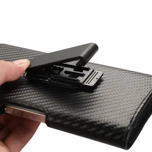 Detailed view of the black carbon fiber texture universal phone pouch with belt clip.