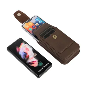 Detail view of brown vertical phone holster with card slots, belt loop and magnetic closure.