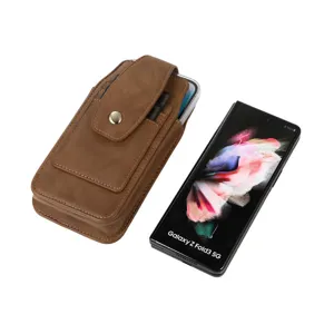 Detailed view of brown leather vertical phone holster with secure snap button and belt loop design.