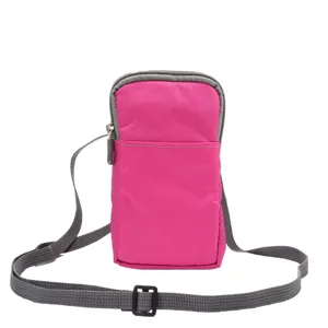 Pink vertical canvas mobile phone crossbody bag with adjustable grey strap and zipper.