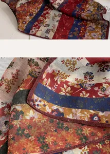 Close-up detail of vintage floral square scarf with ethnic stripe pattern and soft texture.