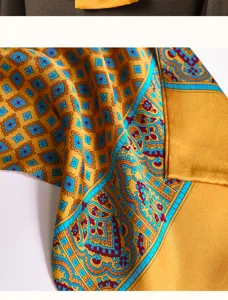 Luxury silk scarf detail for men featuring elegant geometric and paisley patterns in gold and turq.