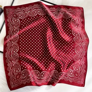 Wine red silk square scarf featuring classic polka dots and paisley borders, elegant accessory.
