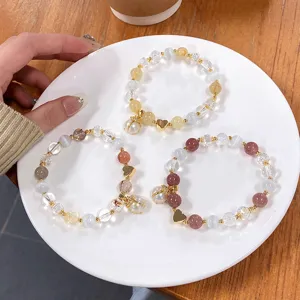 Detail shot of crystal beaded bracelets with cute ladybug and heart charms for sweet stylish wear.