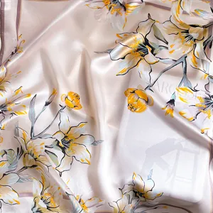 Luxurious pink silk scarf featuring elegant floral lily print, soft mulberry silk fabric.