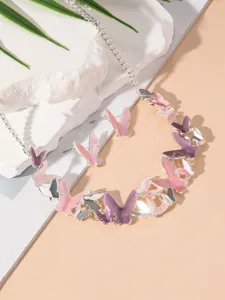 Detailed shot of a butterfly necklace and earrings set featuring pink and purple tones.