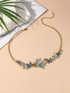 Close-up detail of the vintage style gold-toned chain necklace with colorful butterfly pendants.