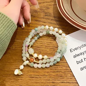 Exquisite multi-layer Tianshan jade bracelet with pearls and delicate gourd pendant.
