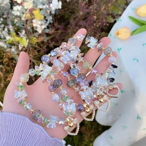 Detail shot of sweet crystal beaded bracelets with cute bows and sparkling heart charms.