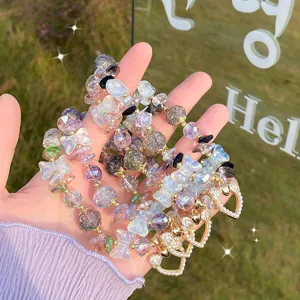 Detailed view of the sweet crystal beaded bracelet with cute bow and heart pendant.