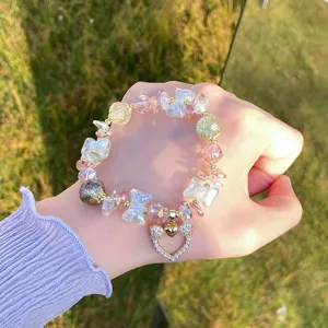 Close-up detail of the sweet crystal beaded bracelet featuring a cute bow and heart pendant.