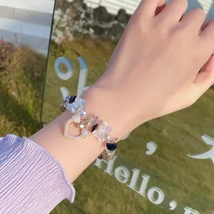 Close-up detail of the sweet crystal glazed bead bracelet featuring charming heart pendant.