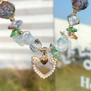 Close-up detail of sweet princess style beaded bracelet with colorful crystals and pearl bow.