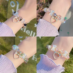 Detailed view of the sweet crystal butterfly and pearl heart bracelet, sparkling style.