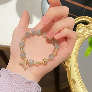 Close-up of the exquisite mermaid tail charm and crystal beads on the elegant bracelet.