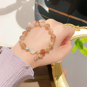 Charming orange moonstone and rutilated quartz crystal bracelet with sparkling mermaid tail charm.