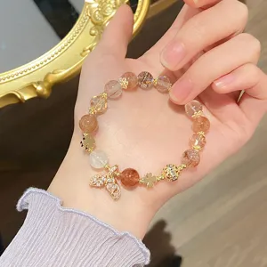 Stunning crystal bracelet featuring strawberry quartz, cute clover charms, and mermaid tail pendant.