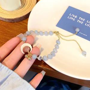 Sweet princess style aquamarine beaded bracelet with crescent moon charm and sliding chain.