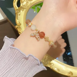 Close-up detail of the crystal bead bracelet featuring a sparkling mermaid tail pendant on wrist.