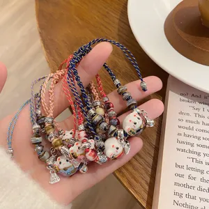 Handcrafted braided lucky cat ceramic charm bracelet set, colorful woven rope friendship jewelry.