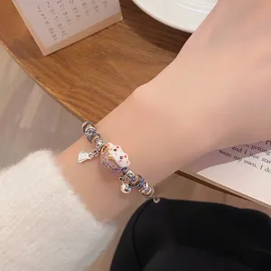 Detail view of a woven ceramic lucky cat beaded bracelet with cute charms for daily wear.