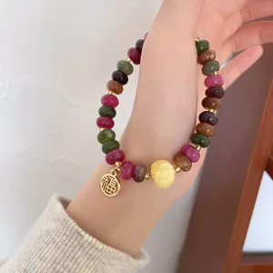 Exquisite colorful gemstone wheel bead bracelet detail view, vintage ethnic style hand jewelry.
