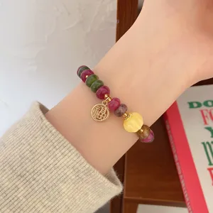 Detailed view of vintage colorful jade wheel bead bracelet with blessing charm for women.