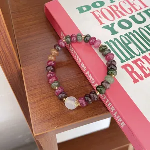 Colorful tourmaline wheel bead bracelet detail view, delicate metal spacers, vintage style.