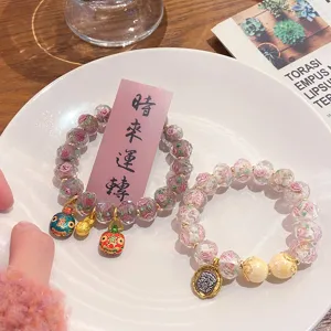 Exquisite glazed rose beaded bracelet with cute charms, elegant sweet princess style jewelry detail.