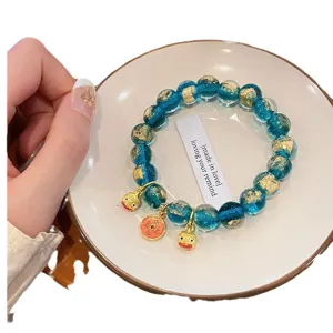 Bracciale in perle di vetro blu foglia d'oro stile cinese con ciondoli di animali.