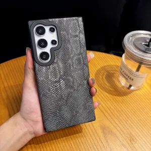 Detailed view of the dark gray snakeskin textured phone case, showing the premium texture.