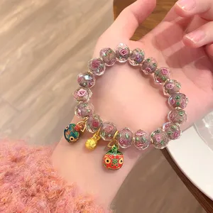 Sweet glass rose beaded bracelet with cute charms, stylish and trendy wrist jewelry for women.