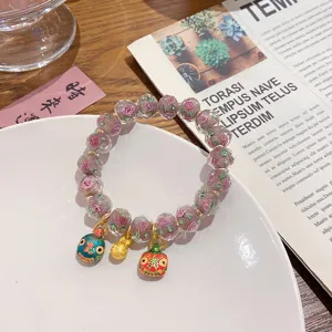 Sweet pink glass rose beaded bracelet with cute mythical beast pendants for women.