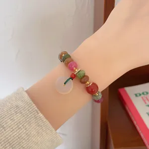 Colorful gemstone wheel bead bracelet detail shot, elegant vintage ethnic style wrist jewelry charm.