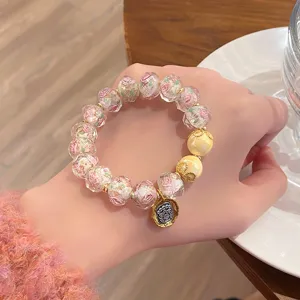 Detail shot of sweet fairy glass rose bead bracelet with mythical beast charm, elegant wrist accessory.