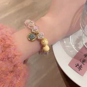 Close-up detail of sweet princess style glass rose beaded bracelet with lucky beast charm.