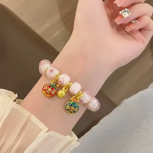 Close-up details of the sweet glass rose bead bracelet with cute charms, exquisite and charming design.