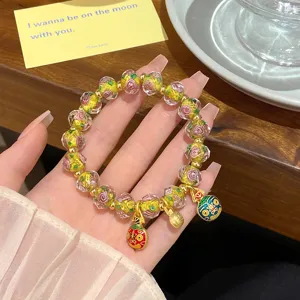 Sweet floral glass bead bracelet with gold charms, princess style aesthetic jewelry detail.