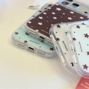 Detailed view of trendy clear phone cases with cute star and polka dot patterns for iPhone.